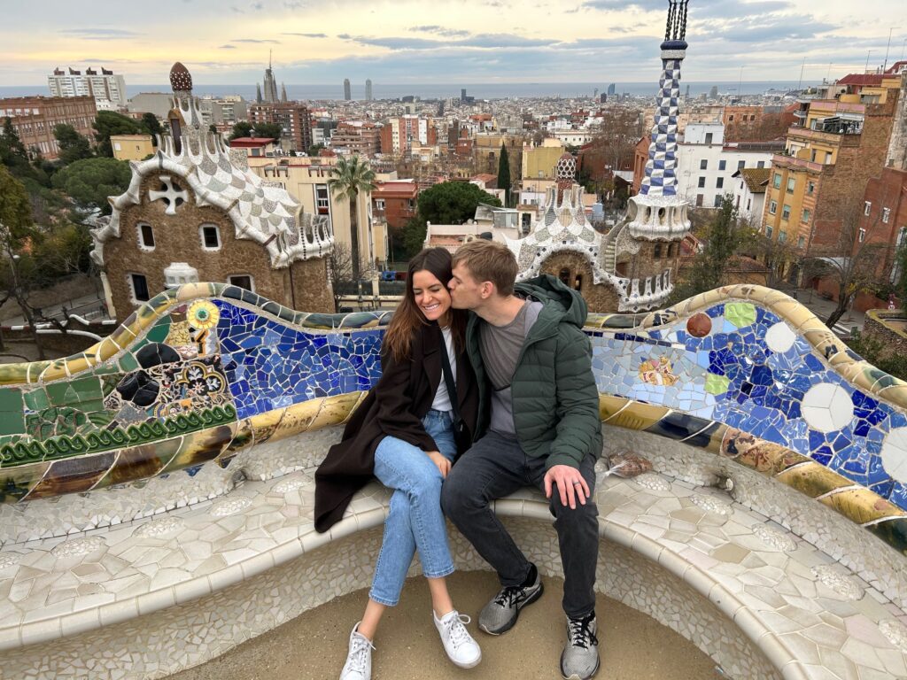 man kissing woman's cheek at Parc Guell in Barcelona