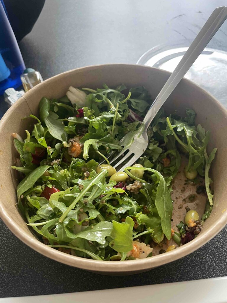 bowl of mixed greens salad with fork