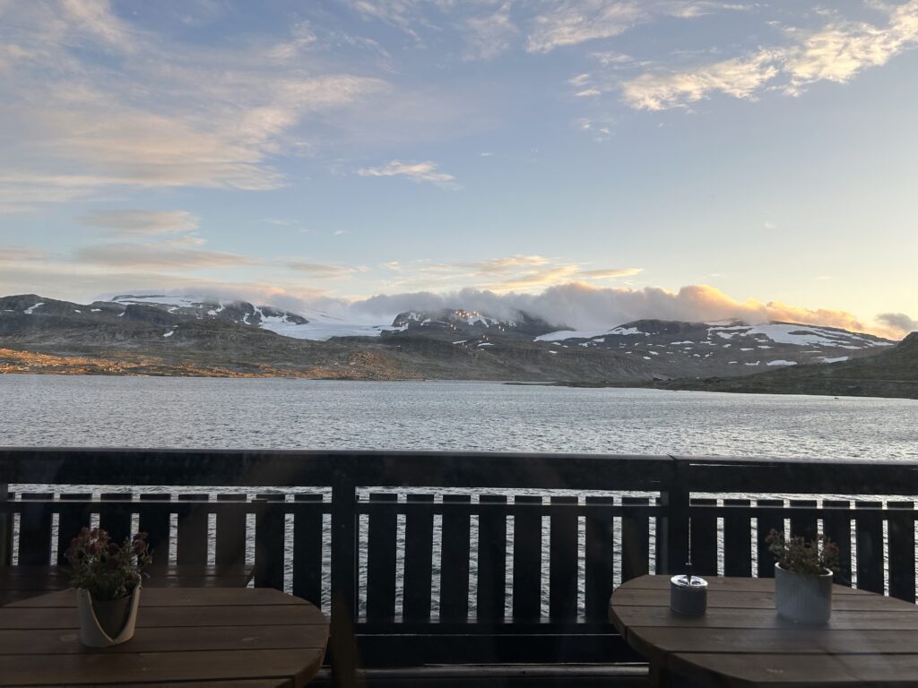 Wooden balcony overlooking water and mountains