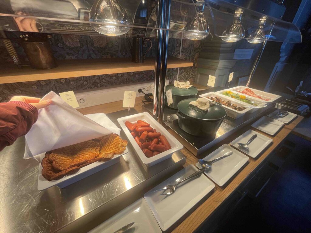 Hotel breakfast buffet with Norwegian waffles, beans, and pots