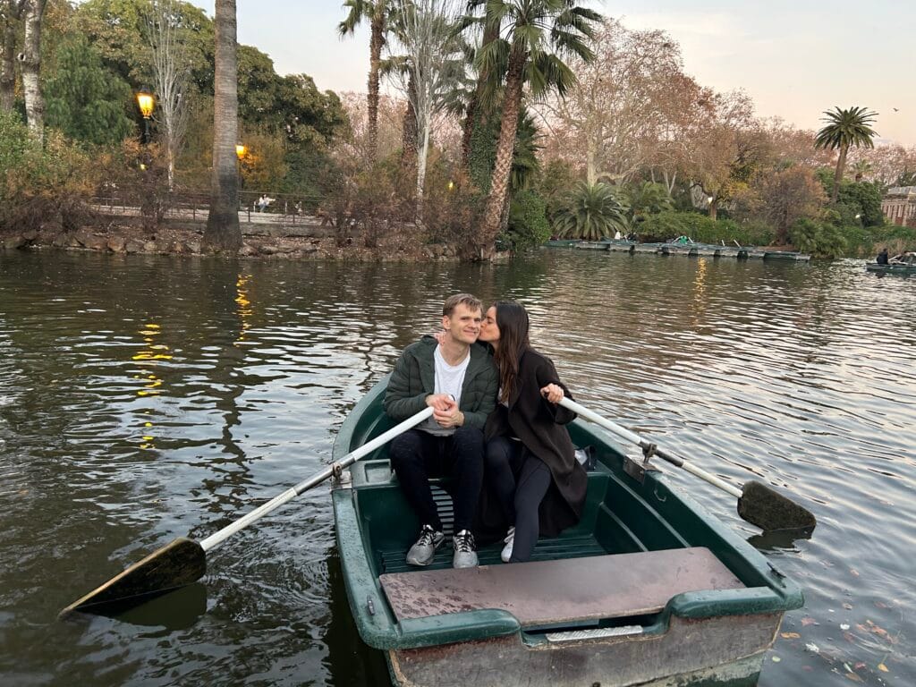 couple kissing in a row boat